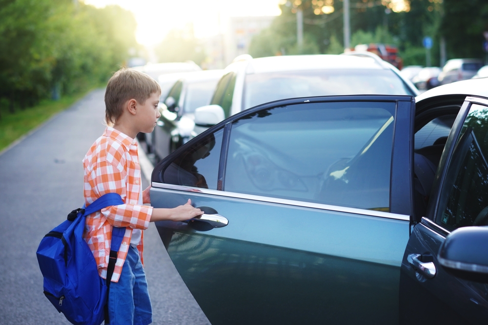 child getting into a car